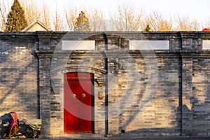 Traditional classic chinese red wood door and ancient brick wall in house, Beijingcity, China