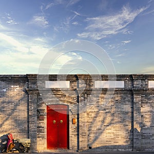 Traditional classic chinese red wood door and ancient brick wall in house, Beijingcity, China