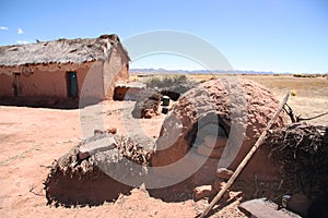 Traditional clay house with a outdoor oven in Bolivia photo