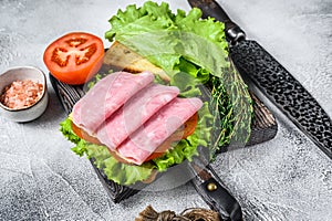 Traditional club sandwiches with turkey ham, cheese, tomatoes and lettuce. White background. Top view