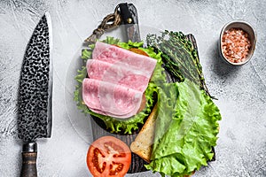 Traditional club sandwiches with turkey ham, cheese, tomatoes and lettuce. White background. Top view