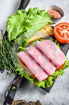 Traditional club sandwiches with turkey ham, cheese, tomatoes and lettuce. White background. Top view