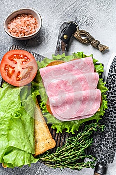 Traditional club sandwiches with turkey ham, cheese, tomatoes and lettuce. White background. Top view