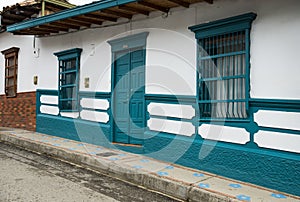 traditional Colombian architecture, white facade with blue door and windows - Entrerrios, Antioquia photo