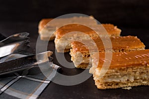 Traditional Colombian dessert Milhojas with tongs photo