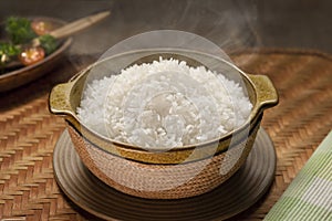 Typical dish of white rice in bowl on wood table photo