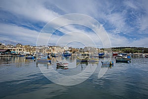 Traditional colorful fishing boats in the harbor of fishing village Marsaxlokk, Malta