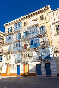 Traditional colorful maltese balconies Gallarija on a building in Valletta old town,  Malta