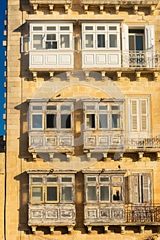 Traditional colorful maltese balconies Gallarija on a building in Valletta old town,  Malta