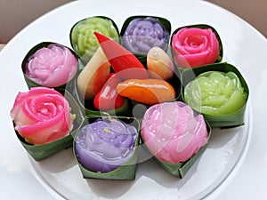 Traditional colorful sweet Thai desserts on a white plate