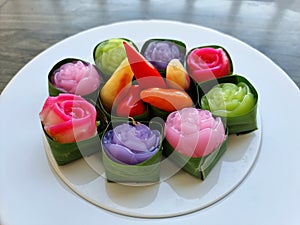 Traditional colorful sweet Thai desserts on a white plate