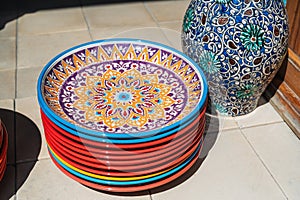traditional colorful Uzbek plates and ceramic vase hand-painted at street oriental bazaar