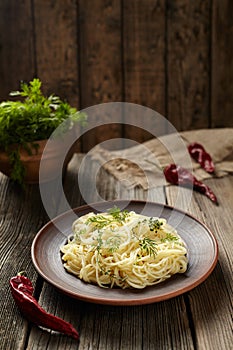 Traditional cooked spaghetti pasta Italian food in clay dish