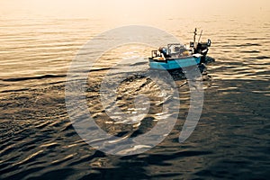 A traditional Cormish fishing boat at sunrise