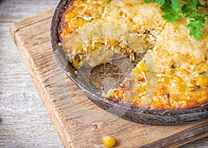 Traditional corn casserole with cheese. Below the corn - parsley mix is ground cheese, olive, egg, baked onion, garlic