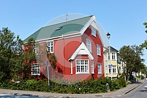 A traditional corrugated metal house in the old section of downtown Reykjavik, Iceland. This house has red siding with white trim