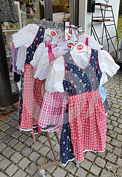 Traditional costumes in Bavaria: Dirndl, typical Alpine clothes for women, colorful selection in stores when shopping,