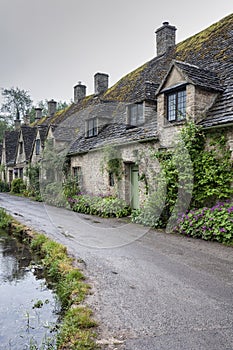 Traditional cotswold stone cottages built of distinctive yellow limestone in the famous Arlington Row, Bibury Gloucestershire UK