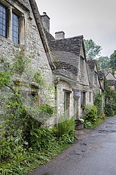 Traditional cotswold stone cottages built of distinctive yellow limestone in the famous Arlington Row, Bibury Gloucestershire UK