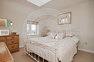 Traditional cottage bedroom with iron bedstead