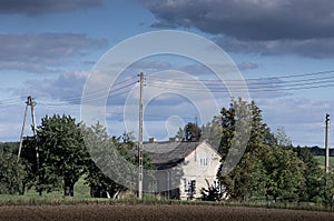 Traditional cottage houses in rural area of Poland on sunny summer day. North of country.