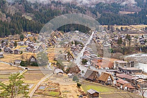 Traditional cottage houses in Shirakawago village with mountain hills in travel trip and holidays vacation in sunmer season, Gifu photo