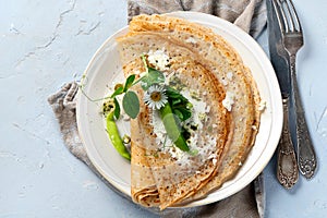 Traditional crepes with filling on gray background photo