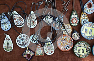 Traditional Crimean Tartar ceramics, painting: trinkets, amulets and pendats placed on tablecloth