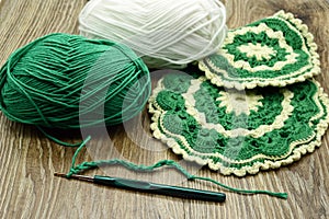 Traditional crochet oven gloves made of green and beige wool