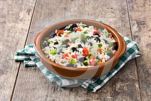 Traditional cuban rice, black beans and pepper on wood. Moros y cristianos.