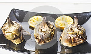 Traditional cuisine: artichokes cooked in the oven with oil and lemon photo