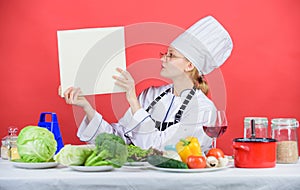 Traditional cuisine. Culinary expert. Woman chef cooking healthy food. Girl read book top best culinary recipes