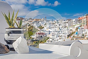 Traditional cycladic whitewashed street with blooming flowers in the summer, Santorini, Greece.