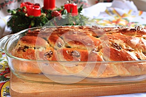 Traditional Czech Christmas cake with candles in the background