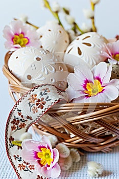 Traditional Czech easter decoration - white perforated lacy eggs