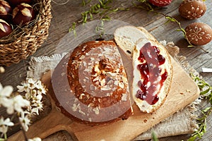 Traditional Czech sweet Easter cake called mazanec with butter and cranberry marmalade, with decorated Easter eggs