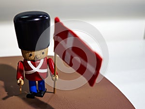 Traditional Danish Royal Guard toy soldier with flag of Denmark