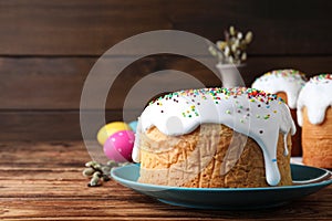 Traditional decorated Easter cake on wooden background, closeup. Space for text