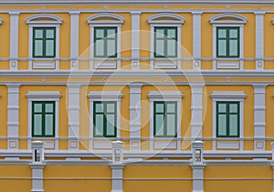 Traditional decorated windows with wooden shutters of old building in Bangkok , Thailand