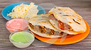 Traditional delicious arepas, shredded chicken avocado and cheddar cheese and shredded beef with grated cheese, avocado photo