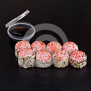 Traditional delicious fresh baked Yaki Roll sushi roll set on a black background with reflection