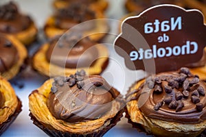 Traditional dessert pastry in Portugal, nata eggs cream cakes with chocolate photo
