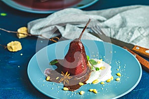 Traditional dessert pears stewed in red wine with chocolate sauce