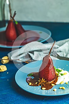 Traditional dessert pears stewed in red wine with chocolate sauce