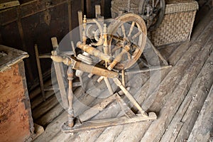 Traditional devices, vintage tailoring equipment concept. Old fashioned wooden distaff, spindle, spinning wheel