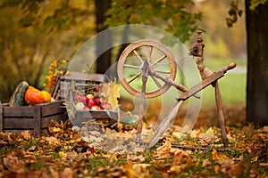 Traditional devices, vintage tailoring equipment concept. Old fashioned wooden distaff, spindle, spinning wheel. Old fashioned