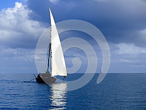 Traditional dhow sailing on a calm sea