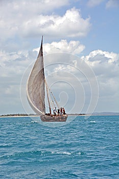 A traditional Dhow sailing in the Indian Ocean, close to the coast of the island of Zanzibar
