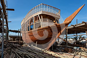 Traditional dhow under construction in wharf in Sur, Oman