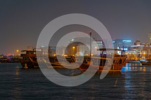 Traditional dhows mooring in Doha in Qatar during night